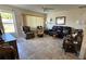 Cozy living room with ample seating, natural light, and tile flooring, perfect for relaxation and entertaining at 11123 Sw 76Th Ter, Ocala, FL 34476