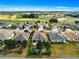 Aerial shot of a home with manicured lawns, landscaping, and beautiful surroundings at 12595 Se 97Th Terrace Rd, Summerfield, FL 34491