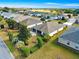 Aerial view of the house, showcasing the backyard, patio, landscaping, and neighborhood at 12595 Se 97Th Terrace Rd, Summerfield, FL 34491