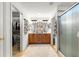 Well-lit bathroom featuring double vanity, a walk-in shower, and a walk-in closet at 12595 Se 97Th Terrace Rd, Summerfield, FL 34491