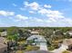 Aerial view of a beautiful house showcasing lush landscaping, a spacious yard, and a well-maintained roof at 13100 Se 94Th Ave, Summerfield, FL 34491