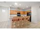 Kitchen featuring an island with bar seating, wood cabinetry, and stainless steel appliances at 13100 Se 94Th Ave, Summerfield, FL 34491