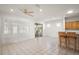 Living room featuring a ceiling fan, tile floors, and access to an enclosed outdoor seating area at 13100 Se 94Th Ave, Summerfield, FL 34491