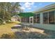 Cozy outdoor patio features a dining area, a vibrant green umbrella, and an inviting space at 13100 Se 94Th Ave, Summerfield, FL 34491