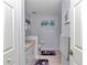 Well-lit bathroom with a granite countertop, framed art, and ceramic tile flooring at 13370 Sw 112Th Pl, Dunnellon, FL 34432