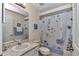 Bathroom with granite-topped vanity and a shower with a floral curtain at 13370 Sw 112Th Pl, Dunnellon, FL 34432