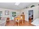 Bright dining area with wood floors, skylight, and sliding glass doors to the backyard at 13370 Sw 112Th Pl, Dunnellon, FL 34432