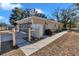 Side view of the house featuring attached garage and fenced-in yard at 13370 Sw 112Th Pl, Dunnellon, FL 34432