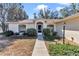 Inviting front entrance with landscaped walkway and charming architectural details at 13370 Sw 112Th Pl, Dunnellon, FL 34432