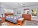 Cozy main bedroom with wood floors, ceiling fan and natural light at 13370 Sw 112Th Pl, Dunnellon, FL 34432