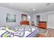 Tranquil main bedroom with a ceiling fan, wood floors, and an en-suite bathroom at 13370 Sw 112Th Pl, Dunnellon, FL 34432