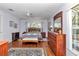 Comfortable bedroom featuring a plush rug, hardwood floors, and bright natural light at 13370 Sw 112Th Pl, Dunnellon, FL 34432