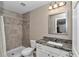 The bathroom features a tiled shower and granite countertops at 13661 Sw 43Rd Cir, Ocala, FL 34473