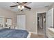 Comfortable bedroom features a ceiling fan, closet, and desk area at 13661 Sw 43Rd Cir, Ocala, FL 34473