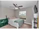 Bedroom features a ceiling fan, a double hung window, and green decor at 13661 Sw 43Rd Cir, Ocala, FL 34473