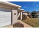 Close up of the home, featuring a long driveway, attached garage, house number and landscaped yard at 13661 Sw 43Rd Cir, Ocala, FL 34473