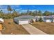 Aerial view of a single Gathering home, showcasing long driveway, attached garage and white fenced-in yard at 13661 Sw 43Rd Cir, Ocala, FL 34473