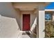 Close up shot of the red front door, and 'welcome' door mat, of a single Gathering home at 13661 Sw 43Rd Cir, Ocala, FL 34473