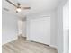 Bright bedroom featuring wood-look floors, a ceiling fan, and a closet at 13910 Sw 113 Ln, Dunnellon, FL 34432