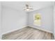 Bright bedroom featuring a modern ceiling fan, light gray walls, and light wood-look flooring at 13910 Sw 113 Ln, Dunnellon, FL 34432