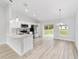 Modern kitchen featuring stainless steel appliances, white cabinetry, and an island with a sink at 13910 Sw 113 Ln, Dunnellon, FL 34432