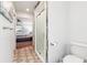 Bathroom featuring a shower, toilet and an open view to the bedroom at 1517 New Abbey Ave, Leesburg, FL 34788