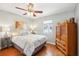 Cozy bedroom featuring hardwood floors, a ceiling fan and a window at 1517 New Abbey Ave, Leesburg, FL 34788