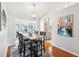 Bright dining room with wood floors, stylish light fixture, and attractive artwork at 1517 New Abbey Ave, Leesburg, FL 34788