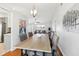 Open-concept dining room featuring modern lighting and seamlessly connects to the living space at 1517 New Abbey Ave, Leesburg, FL 34788