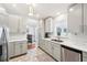 Well-lit kitchen features stainless steel appliances and connects to a cozy dining area at 1517 New Abbey Ave, Leesburg, FL 34788