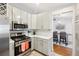 Well-lit kitchen featuring stainless steel appliances, gas range, and white countertops, offering a blend of style and functionality at 1517 New Abbey Ave, Leesburg, FL 34788