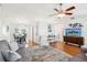 Spacious living room with hardwood floors, modern lighting, comfortable seating and views into dining area at 1517 New Abbey Ave, Leesburg, FL 34788