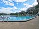 Outdoor pool view showcasing clear blue water and views of mature landscaping and waterfront at 1517 New Abbey Ave, Leesburg, FL 34788