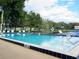 Outdoor pool view showing clear blue water and views of mature landscaping and waterfront at 1517 New Abbey Ave, Leesburg, FL 34788