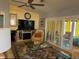 Living room showcasing an entertainment center with fireplace, glass coffee table and sliding glass doors at 15842 Sw 11Th Terrace Rd, Ocala, FL 34473