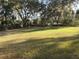 Large grassy backyard with mature trees and natural shade at 17840 Se 28Th Pl, Silver Springs, FL 34488