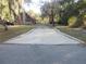 Concrete driveway leading to a unique A-frame home at 17840 Se 28Th Pl, Silver Springs, FL 34488