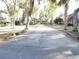 Long concrete driveway leading to the home and carport at 17840 Se 28Th Pl, Silver Springs, FL 34488