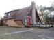 A-frame house with wood siding, deck, and large windows at 17840 Se 28Th Pl, Silver Springs, FL 34488