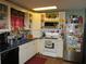 Bright kitchen with white cabinets, blue countertops, and various appliances at 17840 Se 28Th Pl, Silver Springs, FL 34488