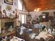 Living room with vaulted wood ceiling, stone fireplace, and comfortable furniture at 17840 Se 28Th Pl, Silver Springs, FL 34488