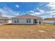 Back exterior of home showing covered patio and sliding door at 3775 Sw 127Th Lane Rd, Ocala, FL 34473