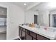 Bathroom featuring double sink vanity with dark wood cabinets and large mirror at 3775 Sw 127Th Lane Rd, Ocala, FL 34473