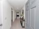 Inviting hallway with tile flooring and stylish console table, leading to the living areas of the home at 3775 Sw 127Th Lane Rd, Ocala, FL 34473