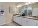 Bathroom with double sink vanity, granite countertops, large mirror, and a glass-enclosed shower at 4038 Nw 48Th Terrace Rd, Ocala, FL 34482