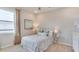 Cozy bedroom showcasing a metal-frame bed, soft colors, and ample natural light from the window at 4038 Nw 48Th Terrace Rd, Ocala, FL 34482