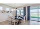 Dining room with a table for six, chandelier, and sliding doors leading to a patio with a lake view at 4038 Nw 48Th Terrace Rd, Ocala, FL 34482