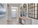 Bright foyer featuring tile floors, console table with decorative mirrors, and direct view of front door at 4038 Nw 48Th Terrace Rd, Ocala, FL 34482