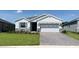 Inviting single-story home boasting a well-manicured lawn, stone accents, and an attractive two-car garage at 4062 Nw 48Th Terrace Rd, Ocala, FL 34482