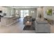 Open concept living area with grey sectional sofa and access to the backyard at 4062 Nw 48Th Terrace Rd, Ocala, FL 34482